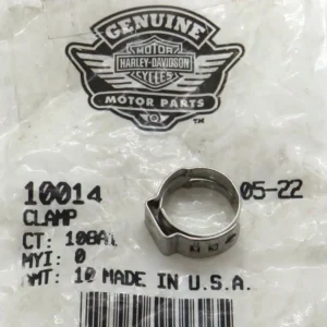 Harley-Davidson Genuine Motor Parts logo on a plastic bag, with a silver metal clamp resting on the surface.