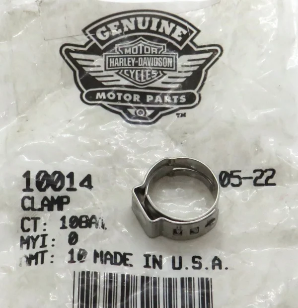 Harley-Davidson Genuine Motor Parts logo on a plastic bag, with a silver metal clamp resting on the surface.