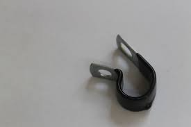 Small black U-shaped clamp with metal mounting tabs on a light background, likely used to secure a hose or cable