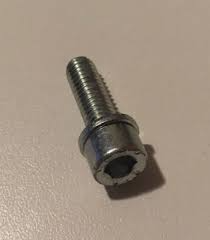 Close-up of a small metal bolt with a flanged washer on a beige surface, threaded shaft visible.