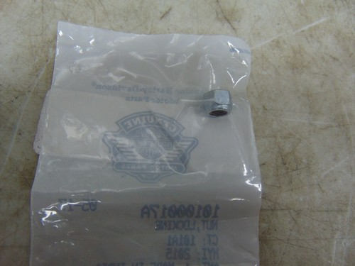 Transparent plastic bag with a faint blue logo lies on a beige work surface; a small metal cylindrical piece rests near the edge inside the bag.