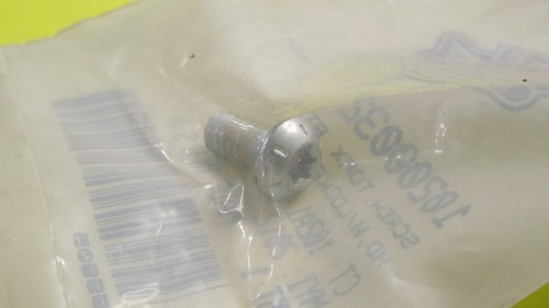10200032 | Harley-davidson® Online Metal bolt inside a clear plastic bag with a barcode visible in the background.