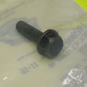 Black hex bolt with threaded shaft resting on a pale plastic bag.