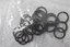 Tangled black metal chain links with small plastic spacers, resting on a light surface.
