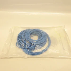 Coiled blue Ethernet network cable in a clear plastic bag on a white surface, ready for packaging or storage.
