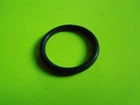 Black circular ring resting on a bright neon-green surface