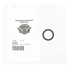 White envelope or card with a barcode label and a large black ring/slotted circle on the right side.