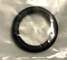 11391k | Harley-davidson® Online Round black rubber O-ring on a clear plastic bag, resting on a wrinkled surface.