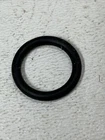 Black rubber O-ring resting on a light textured background