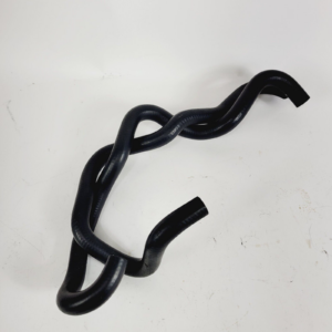 Black flexible rubber hose twisted into loops on a white surface, showing multiple curves and bends.