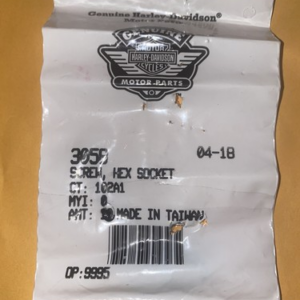 White Harley‑Davidson Genuine Motor Parts bag label with logo, barcode, date 04‑18, and 'Made in Taiwan' text.