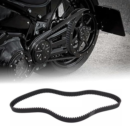 Close-up of a motorcycle’s chain drive with a toothed rubber drive belt laid on the ground.