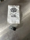 Small sealed plastic bag with a printed label and barcode on a metal surface.