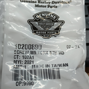 Genuine Harley‑Davidson Motor Parts packaging featuring the logo and a barcode, photographed close up.