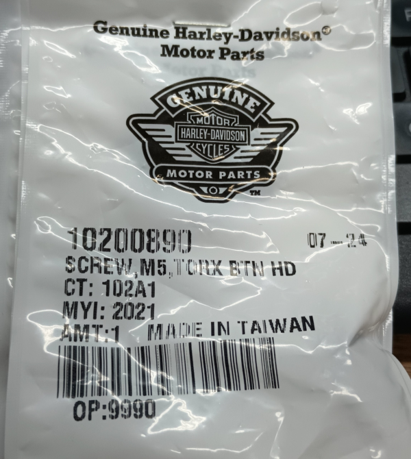 Genuine Harley‑Davidson Motor Parts packaging featuring the logo and a barcode, photographed close up.