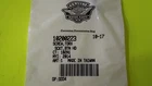 White store receipt with a printed barcode and a logo at the top, lying on a bright green surface.