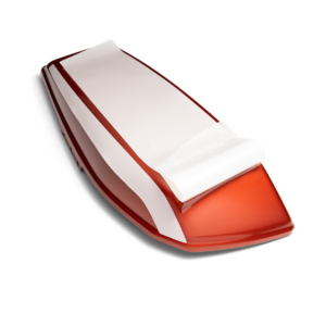 Red and white paper cutter/trimmer on a white background, handheld with a sliding blade in a desk setup.