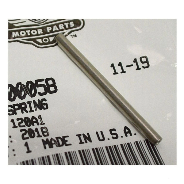 Close-up of a silver metal rod resting diagonally on a white tag showing MADE IN U.S.A., 11-19, a barcode, and a Motor Parts logo.