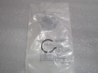Small clear plastic bag on a light surface, showing a circular logo and printed text inside.