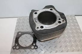 Metal engine cylinder head with cooling fins and a circular gasket on a diamond-plate work surface