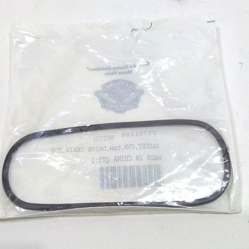 Black oval automotive drive belt sealed in clear plastic packaging.