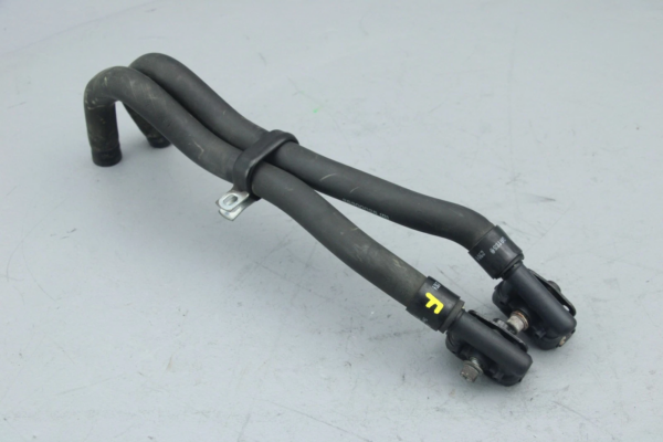 Twin black rubber automotive hoses with metal clamps and a tension strap, part of a vehicle hose assembly.