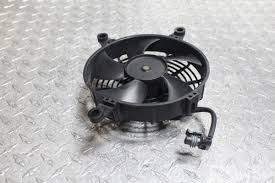 Car radiator cooling fan with mounting shroud on a diamond-plate surface
