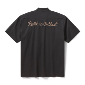 Back view of a dark short-sleeve shirt with tan embroidered text: 'Built to Outlast'.
