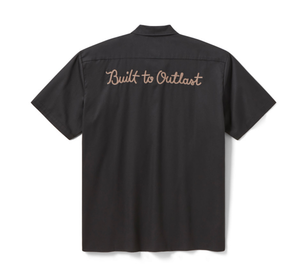 Back view of a dark short-sleeve shirt with tan embroidered text: 'Built to Outlast'.