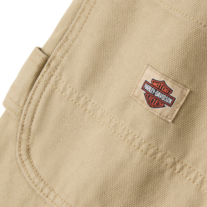 Beige canvas bag with a small Harley-Davidson logo patch sewn onto the fabric.