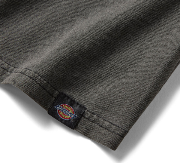 Close-up of a dark gray sleeve hem with a small Dickies logo tag woven into the seam.