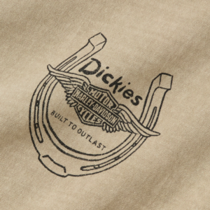 Dickies logo on beige fabric with wings surrounding a circular emblem and the slogan 'Built to Last'.
