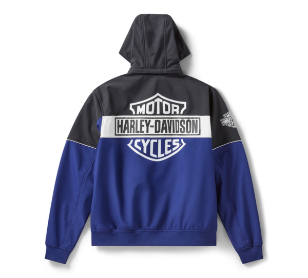 Back view of a blue and black Harley-Davidson motorcycle jacket with a large Motor Harley‑Davidson Cycles logo across the upper back and a white stripe; small emblem on the right sleeve shows the Harley logo.