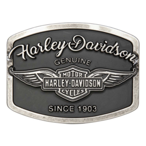Harley-Davidson belt buckle with winged emblem and 'Since 1903' inscription on a dark background.